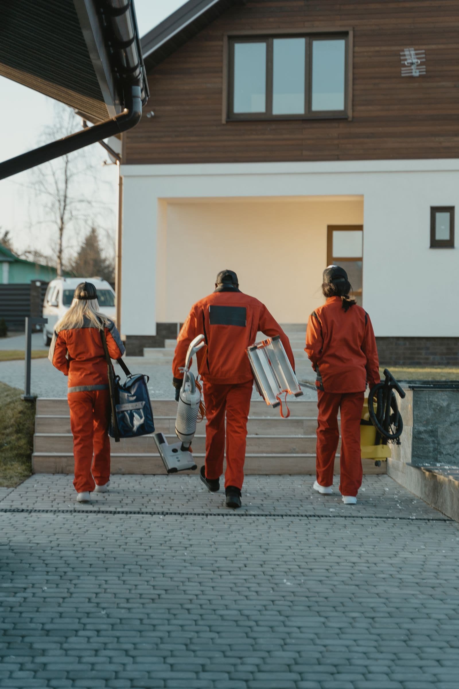 Technician preparing exterior cleaning equipment at a residential job