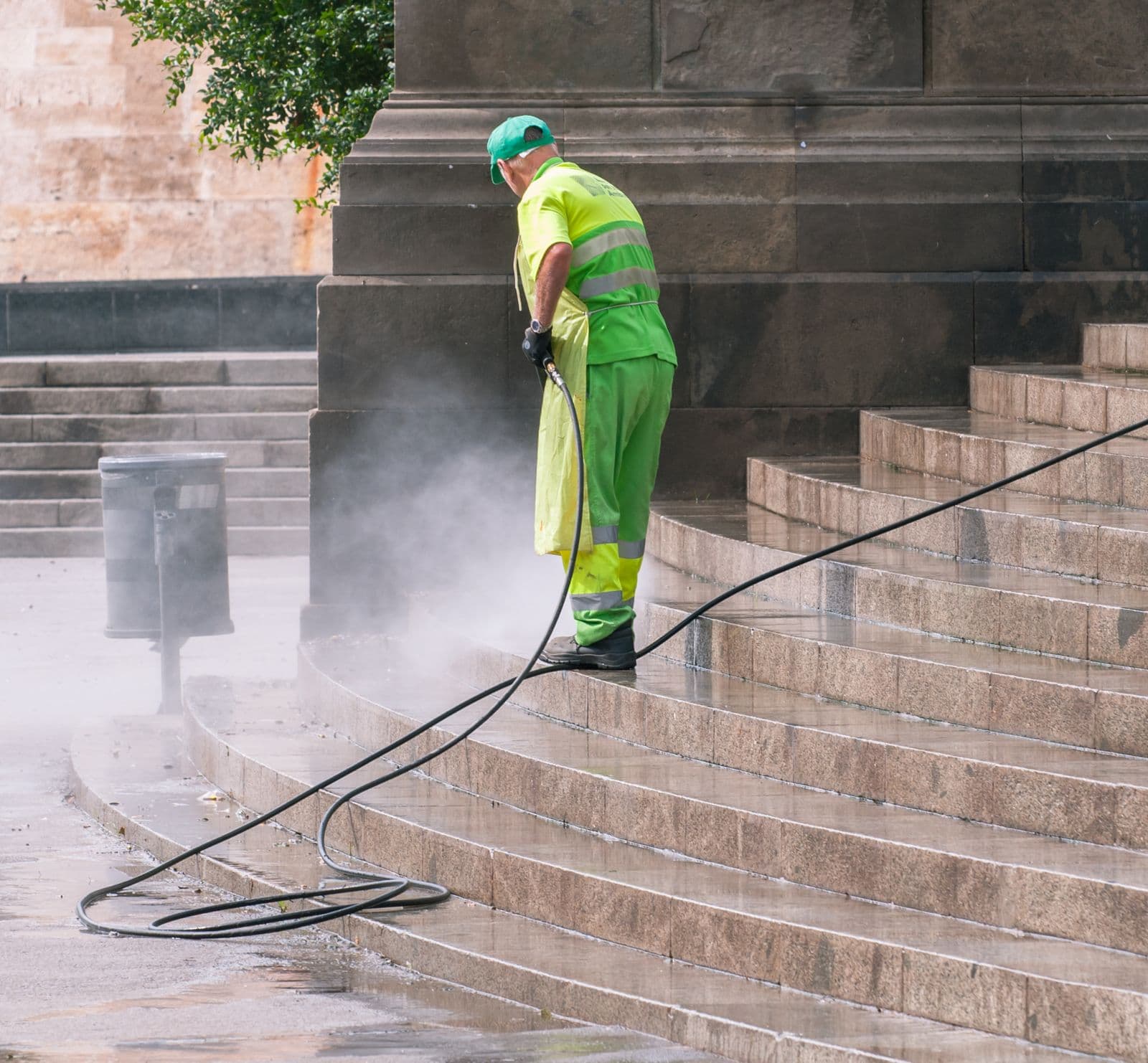 Surface cleaner removing grime from a concrete driveway, showing a clean stripe